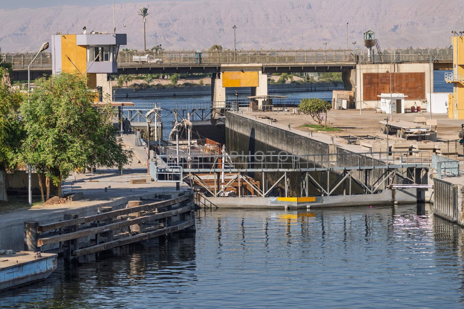 Approaching the new Esna dam and lock on Nile River with dahabiya going through the lock