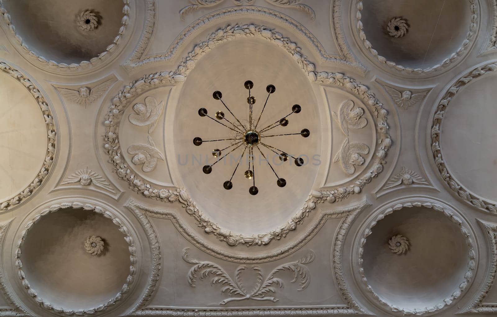 Royal Tunbridge Wells, UK - Apr 29, 2025 - Look up at A stunning chandelier hanging on The ceilings are made of plaster is carved into a dome shape interior of The Church of King Charles the Martyr. use it as your Wallpaper, Poster and Copy space, Selective focus.