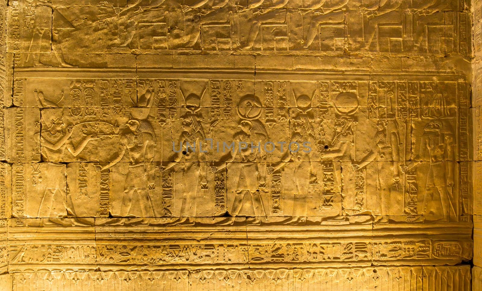 Detail of the carved images inside the temple in Edfu dedicated to Horus and Hathor showing gods meeting pharoah