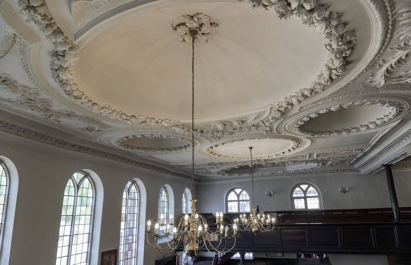 Royal Tunbridge Wells, UK - Apr 29, 2025 - Architectural splendour interior of The Church of King Charles the Martyr with chandelier hanging on ceiling are made of plaster with five domes and glass windows. use it as your Wallpaper, Poster and Copy space, Selective focus.