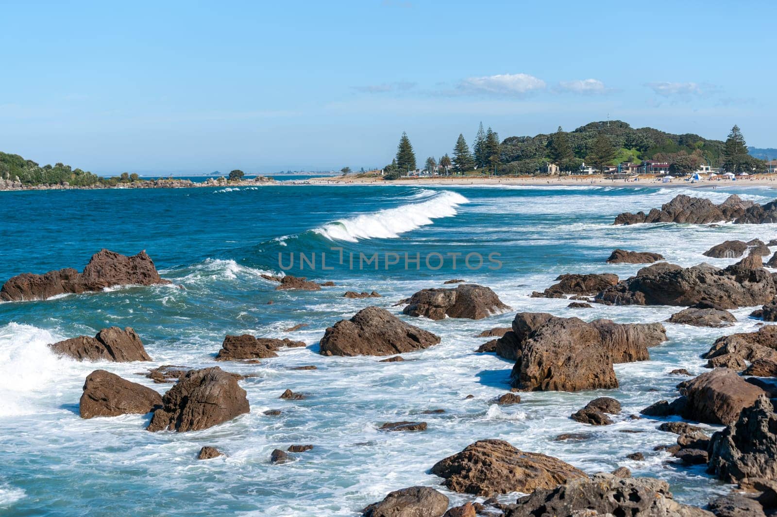 Rocky foreshore and surf at base of Mount Maunganui New Zealand.