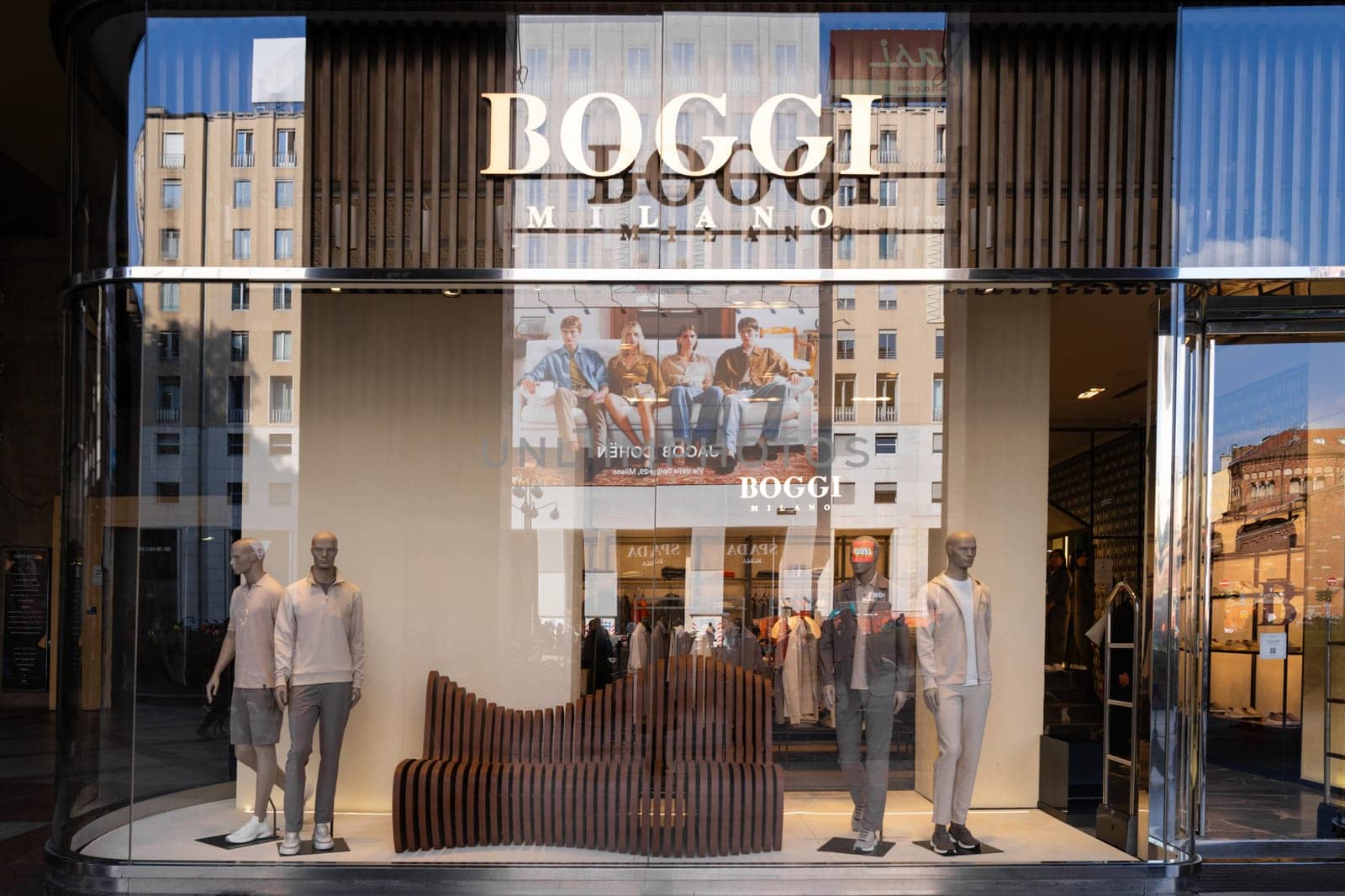 Milan, Italy - April, 08, 2025: Boggi Milano store exterior with modern menswear display and mannequins. Fashion storefront in Milan with brand signage, reflection.