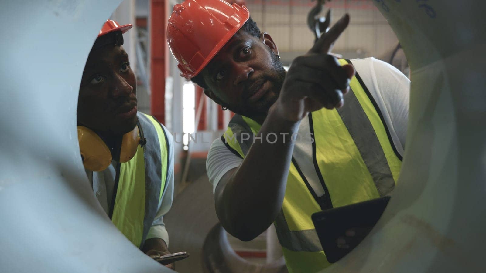 Engineer two worker man African black marking inspection on roll metal sheet before shipment in warehouse of Metal Sheet factory, Physical inventory count, checking stock industry