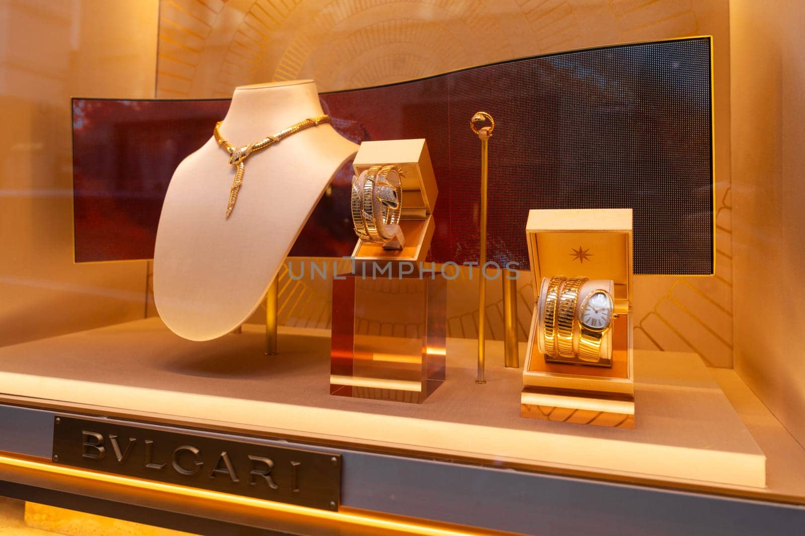 Milan, Italy - April, 08, 2025: BVLGARI jewelry window display. Serpenti necklace, gold bracelets and luxury watch. Milan boutique close-up showcase.