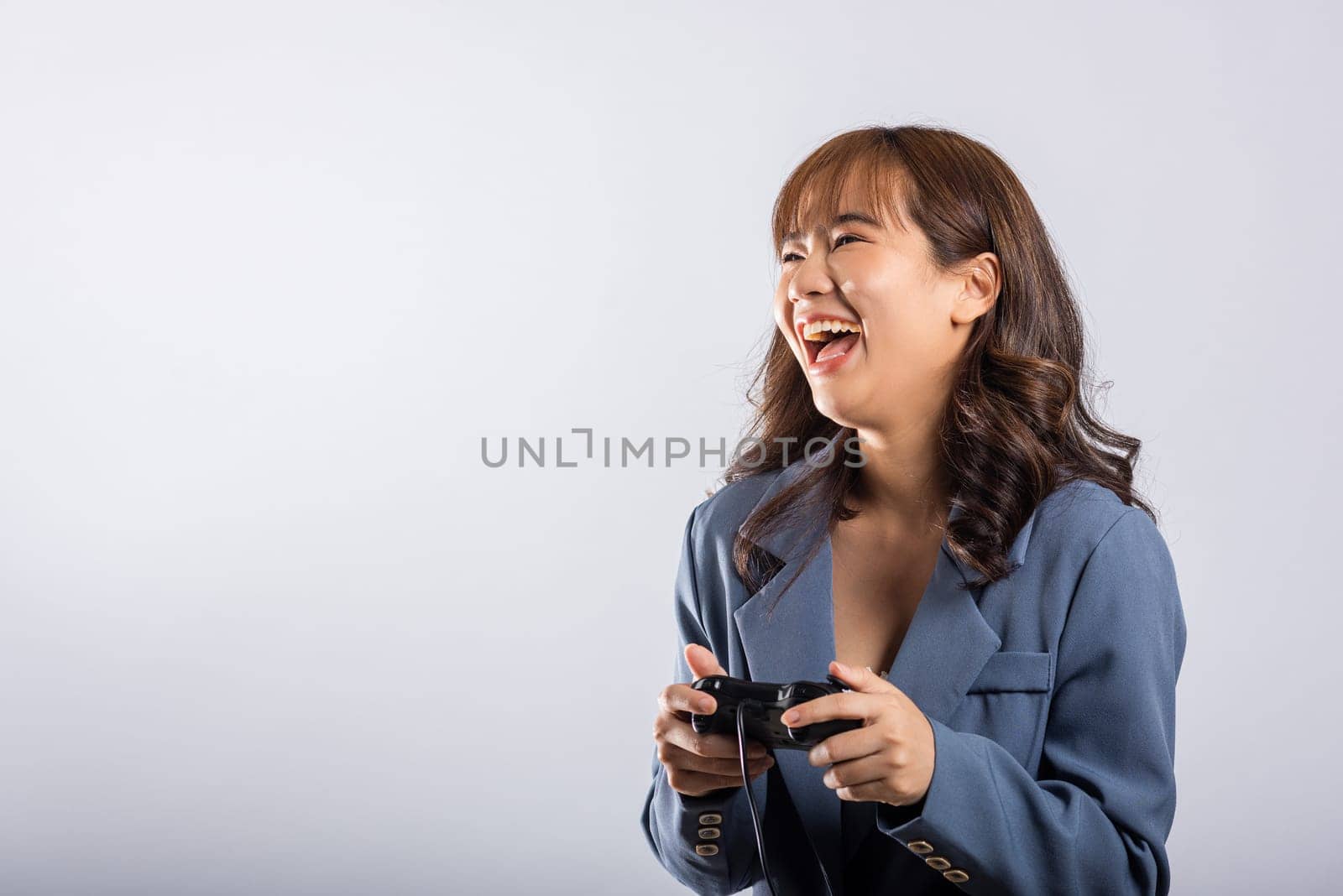 Asian happy portrait beautiful business woman wearing a suit smile lifestyle games technology her holding joystick game playing on hands on white background with copy space for text, Relaxation time