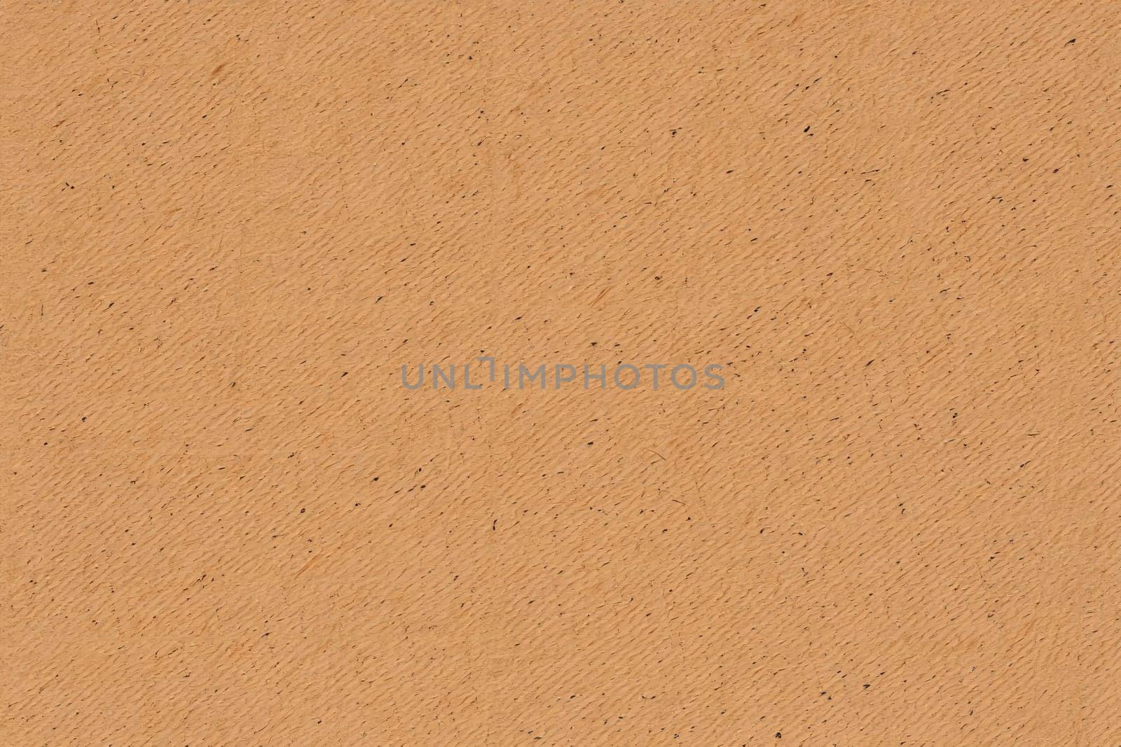 A close up view of textured paper reveals a warm orange color with a fine grain and slight variations. The organic feel makes it suitable for creative projects and crafts.
