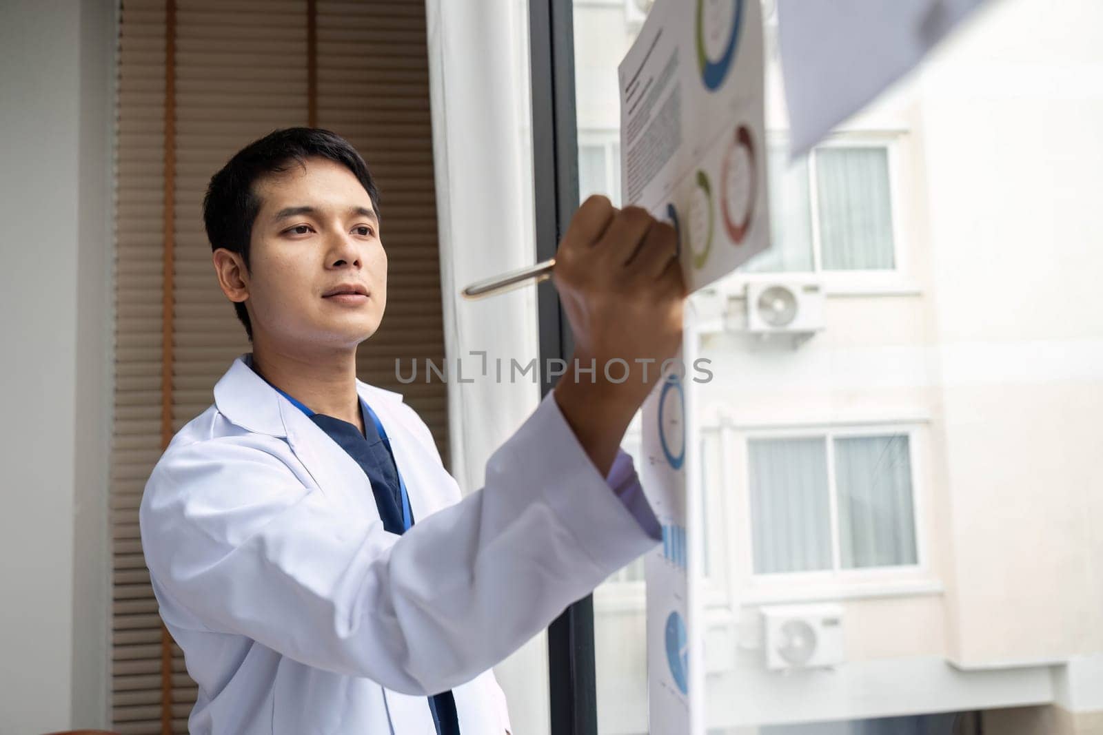 A doctor presenting data insights from charts during a hospital meeting, focusing on collaborative efforts to enhance medical practices.