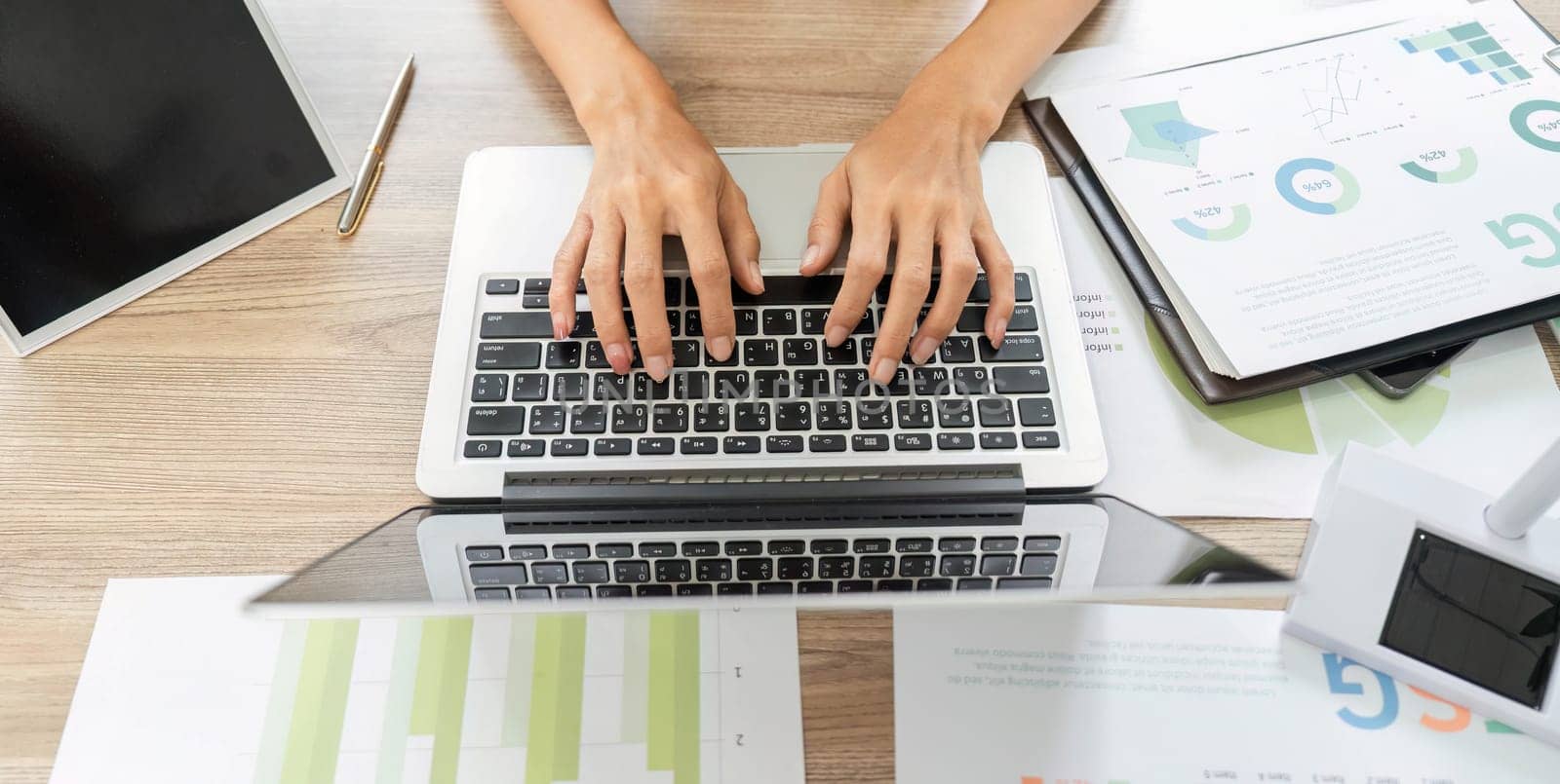 An ESG sustainability analyst engaged with data on a laptop in a collaborative workspace, highlighting a focus on environmental and social governance.