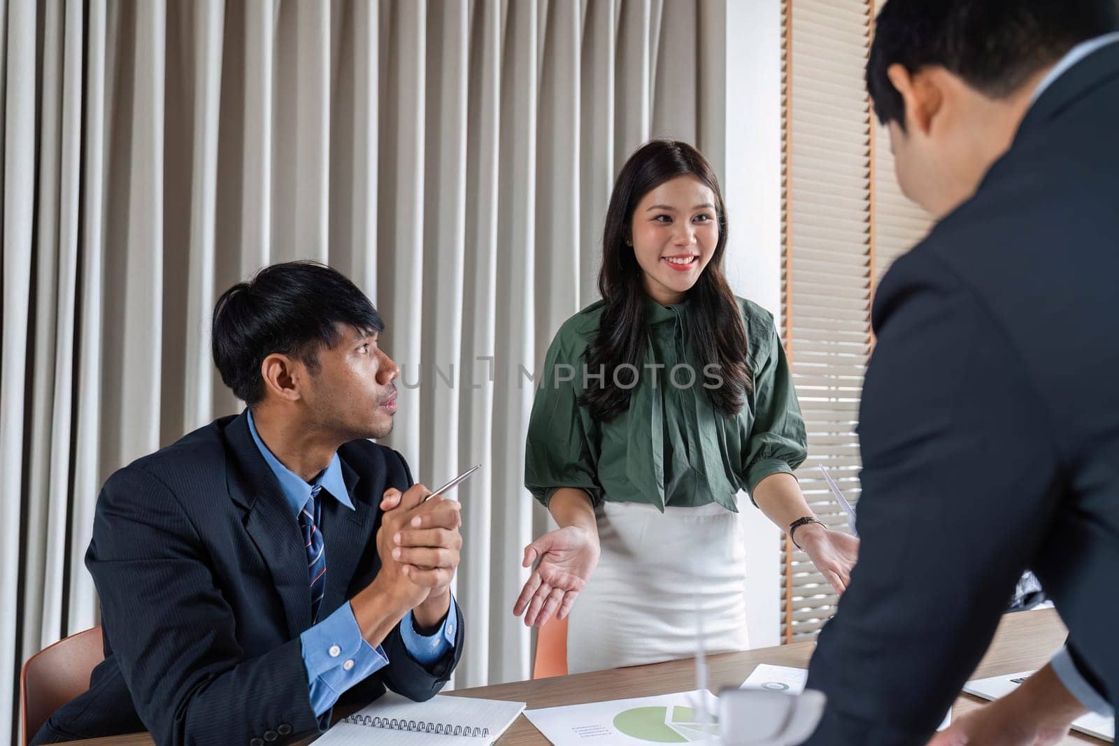 Professionals engaged in discussion during a meeting, focusing on ESG strategies and sustainable practices in a business context.