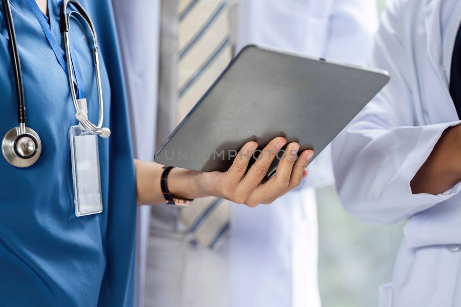 A healthcare professional using a tablet to access patient records, improving the consultation process.