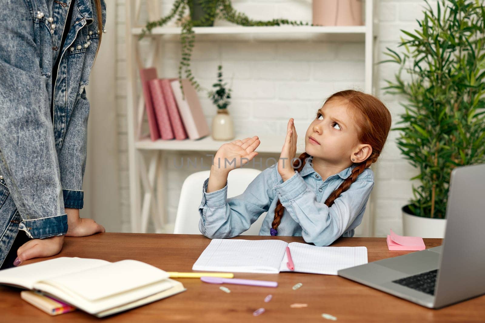little redhead child girl child does not want to study online. mom makes daughter learn lessons. hard online lesson at home