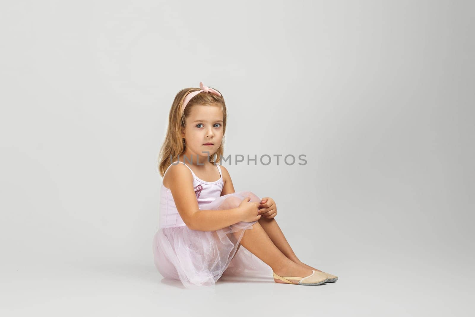 little child girl dreams of becoming a ballerina. ballet dancer in pink tutu