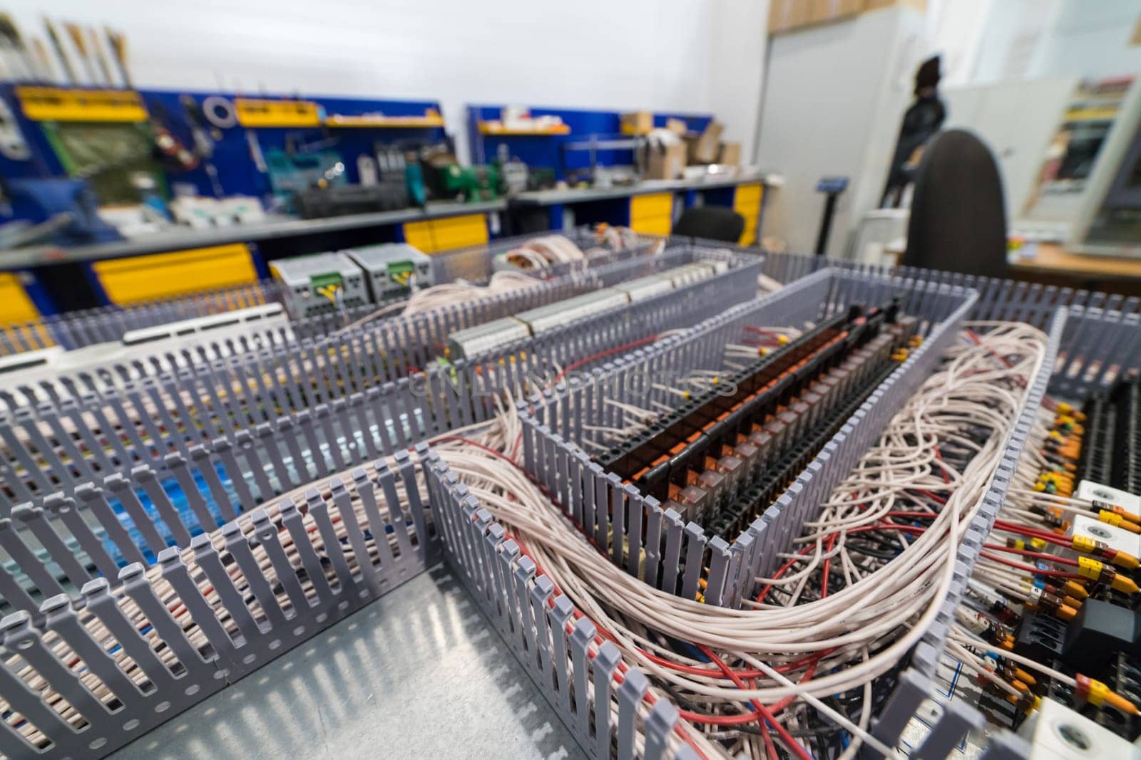 Close-up of an electrical cabinet showing organized wiring and relays, highlighting the complexity of industrial control systems