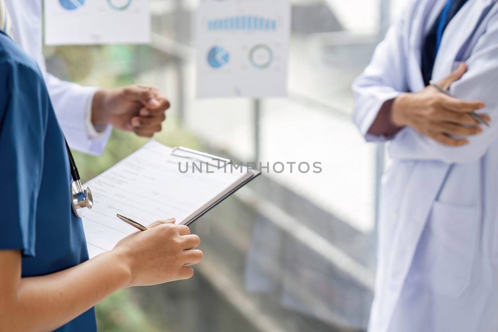 A doctor explaining patient care strategies with the help of charts and visuals, showcasing clear communication and teamwork.