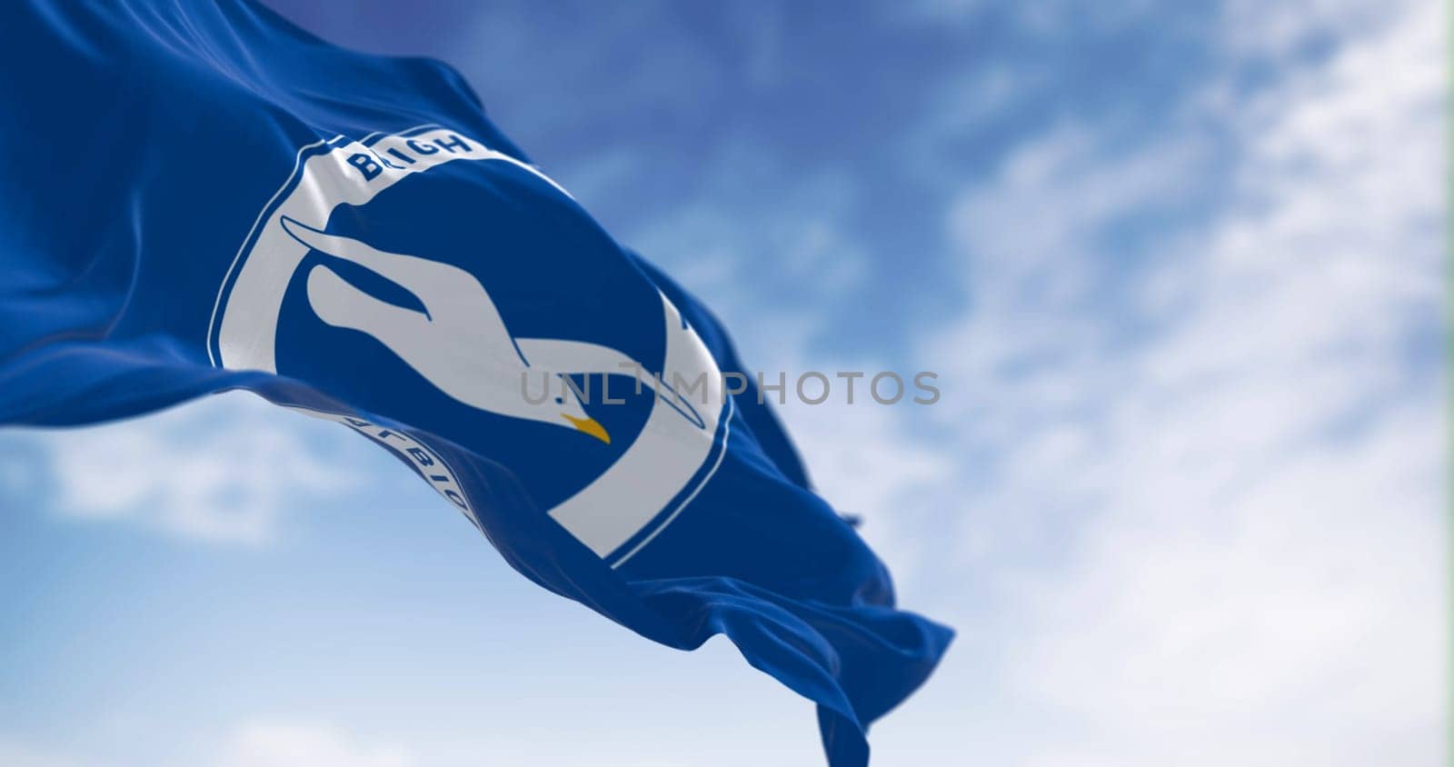 Brighton, UK, May 2023: Brighton and Hove Albion Football Club flag waving in the wind on a clear day. English Premier League team. Illustrative editorial 3d illustration render. Selective focus