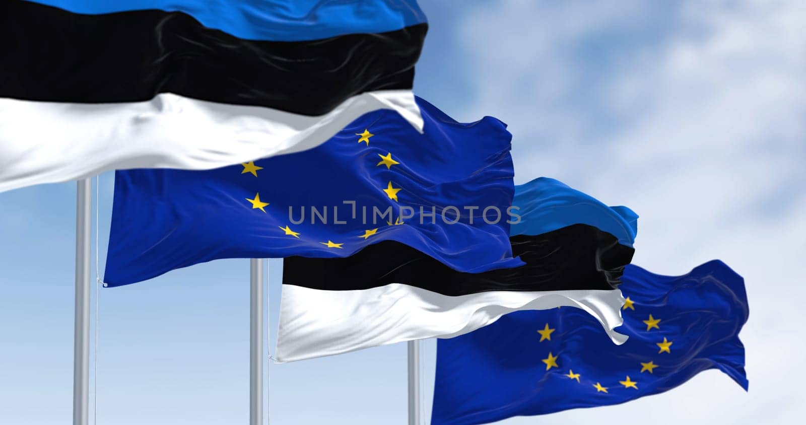 The flags of Estonia and the European Union waving together on a clear day. Estonia became a member of the European Union on May 1, 2004. Realistic 3d illustration. International treaty and diplomacy