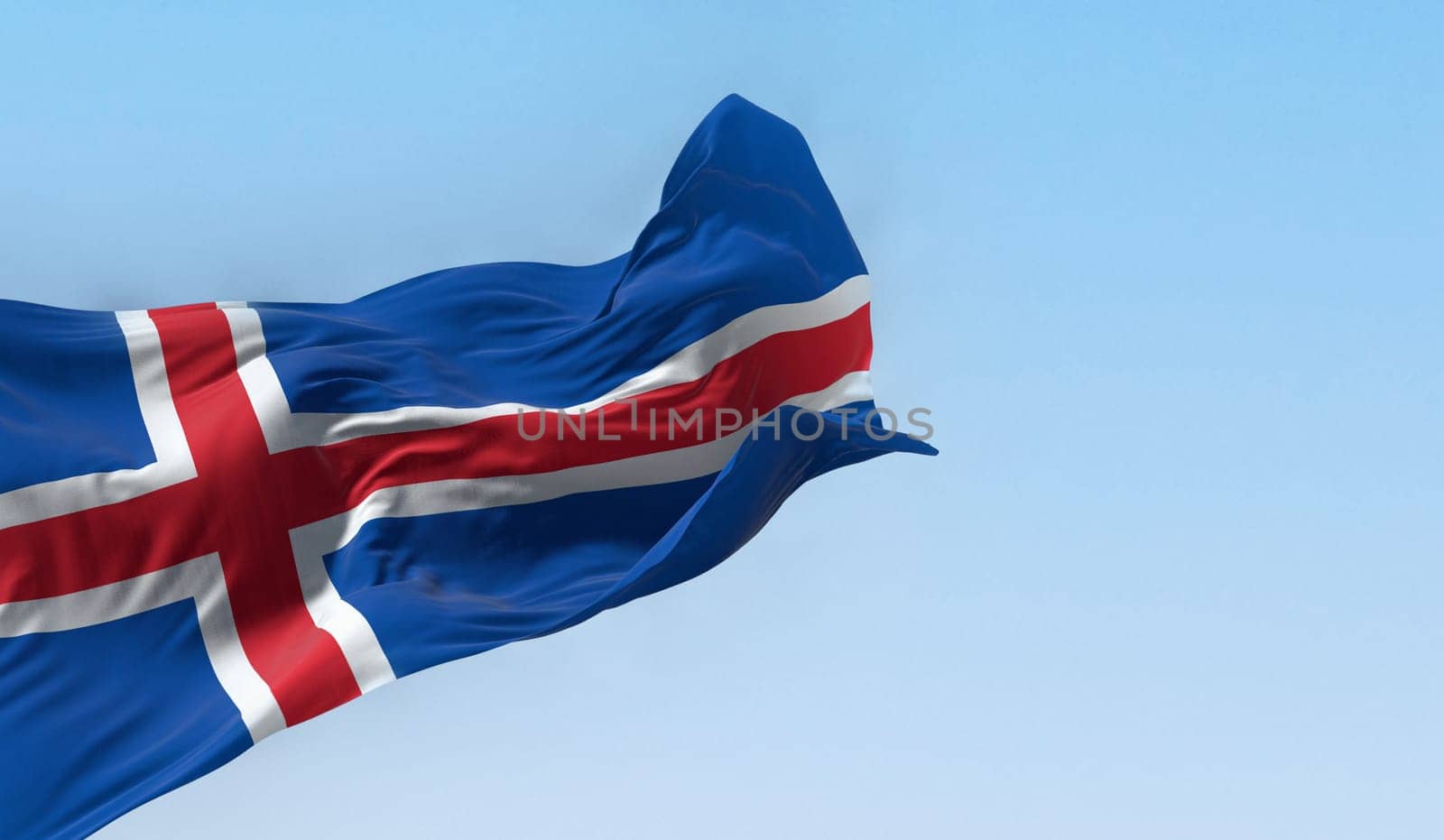 Close-up view of the Iceland national flag waving in the wind. Blue flag with a white-edged red Nordic cross. 3d illustration render. Fluttering fabric.