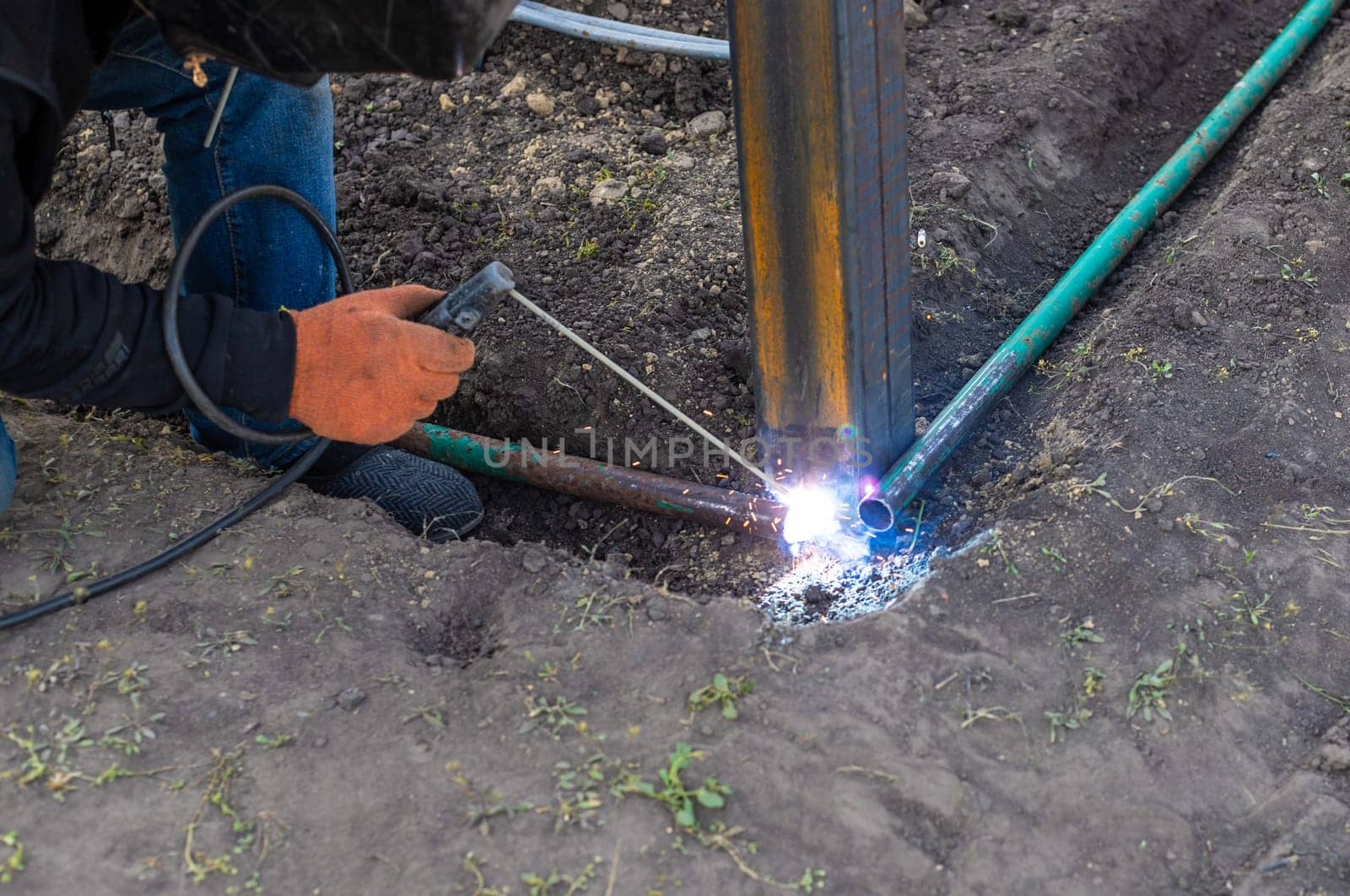 A man doing welding work. Selective focus. People.