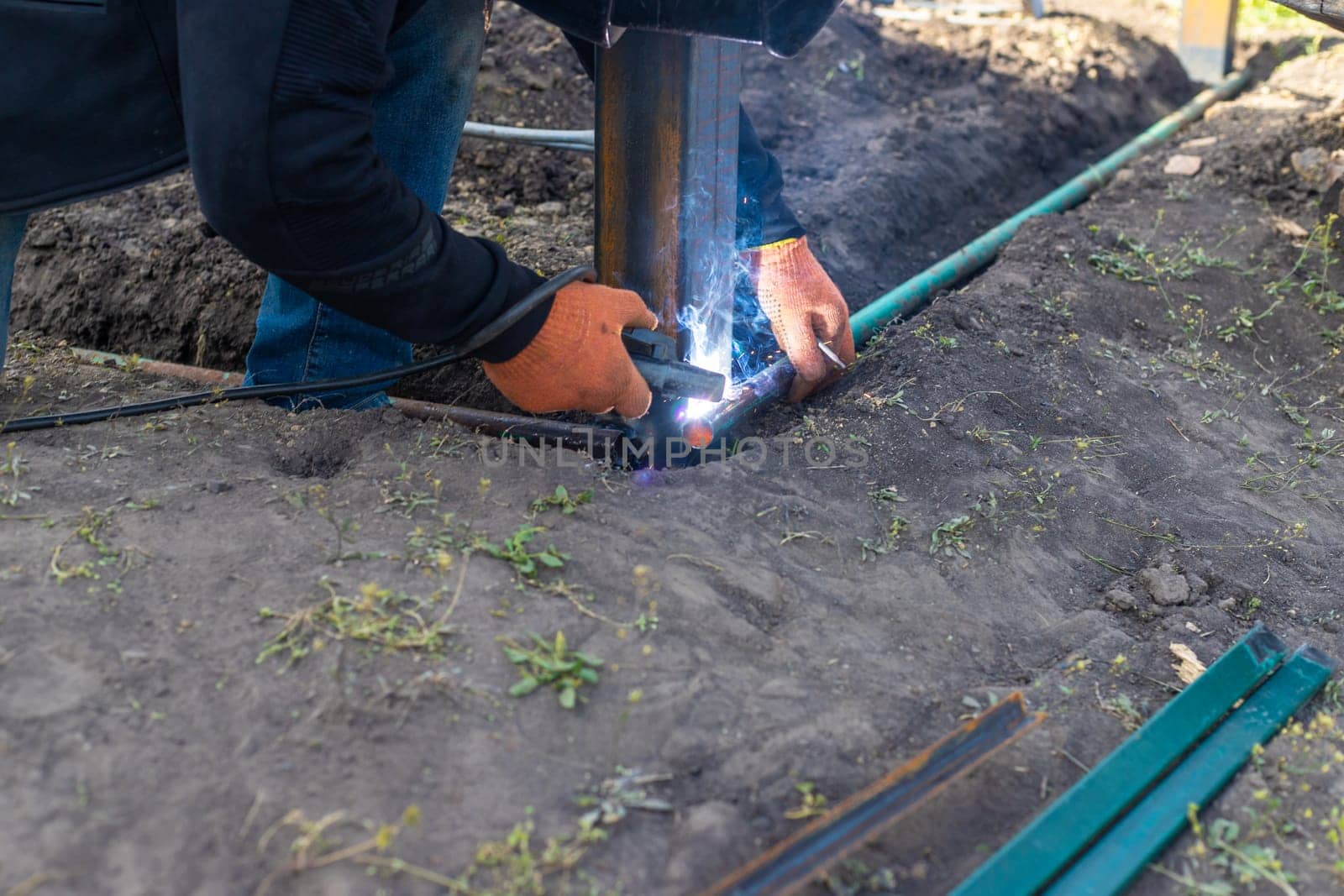 A man doing welding work. Selective focus. People.