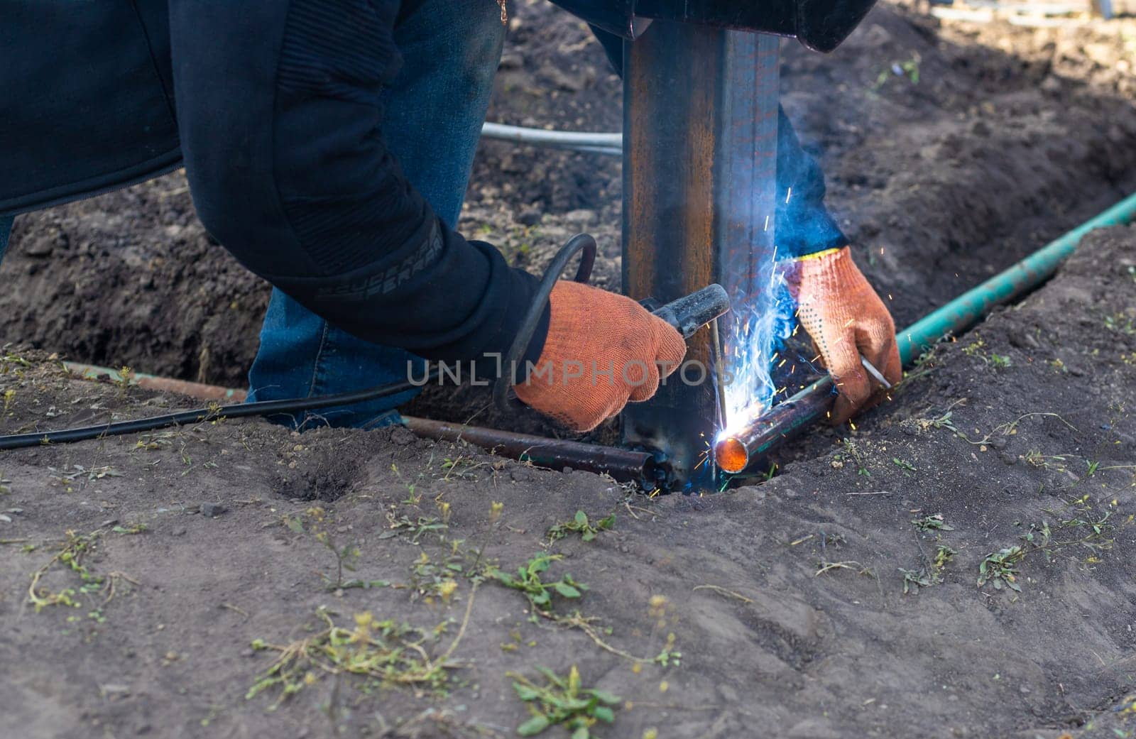 A man doing welding work. Selective focus. People.