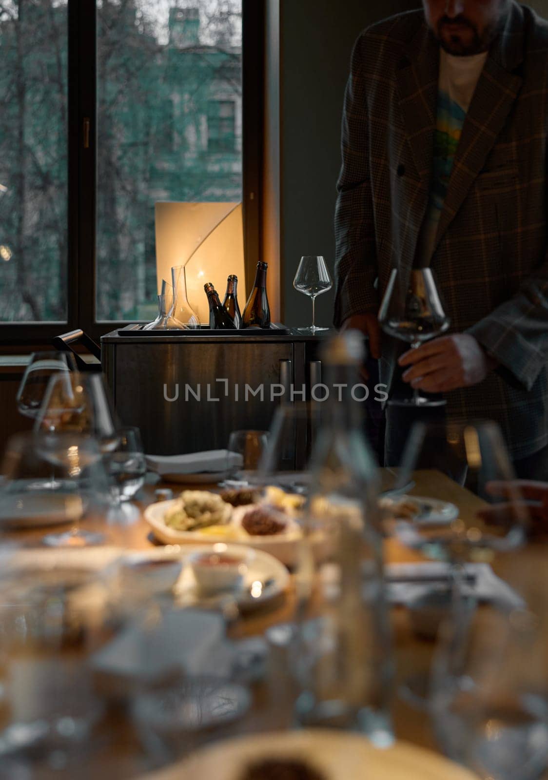 Several bottles of champagne are cooled in a niche with ice in the restaurant, local lighting, wine cabinet, decanters for sparkling wine. High quality photo