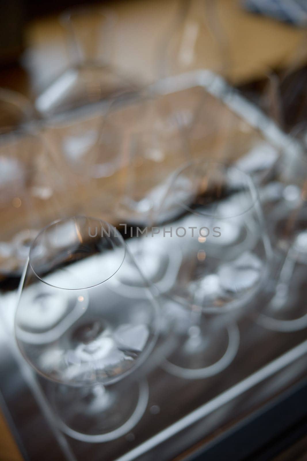 Clean wine glasses are on the table of a special wine cabinet, stylish table setting, ice, bottle of sparkling wine, light from window, decanter and degasser. High quality photo