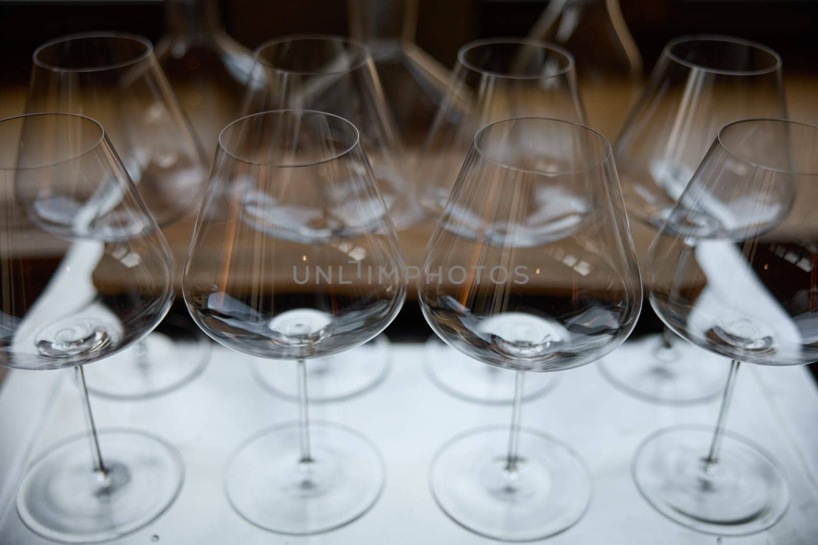 Clean wine glasses are on the table of a special wine cabinet, stylish table setting, ice, bottle of sparkling wine, light from window, decanter and degasser. High quality photo