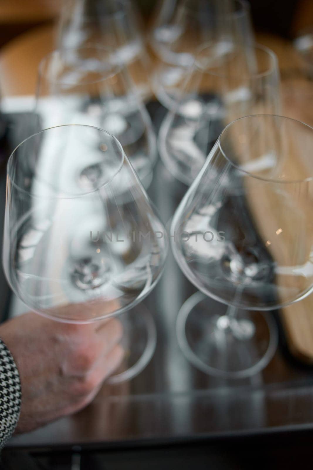 Clean wine glasses are on the table of a special wine cabinet, stylish table setting, ice, bottle of sparkling wine, light from window, decoder and degasser. High quality photo