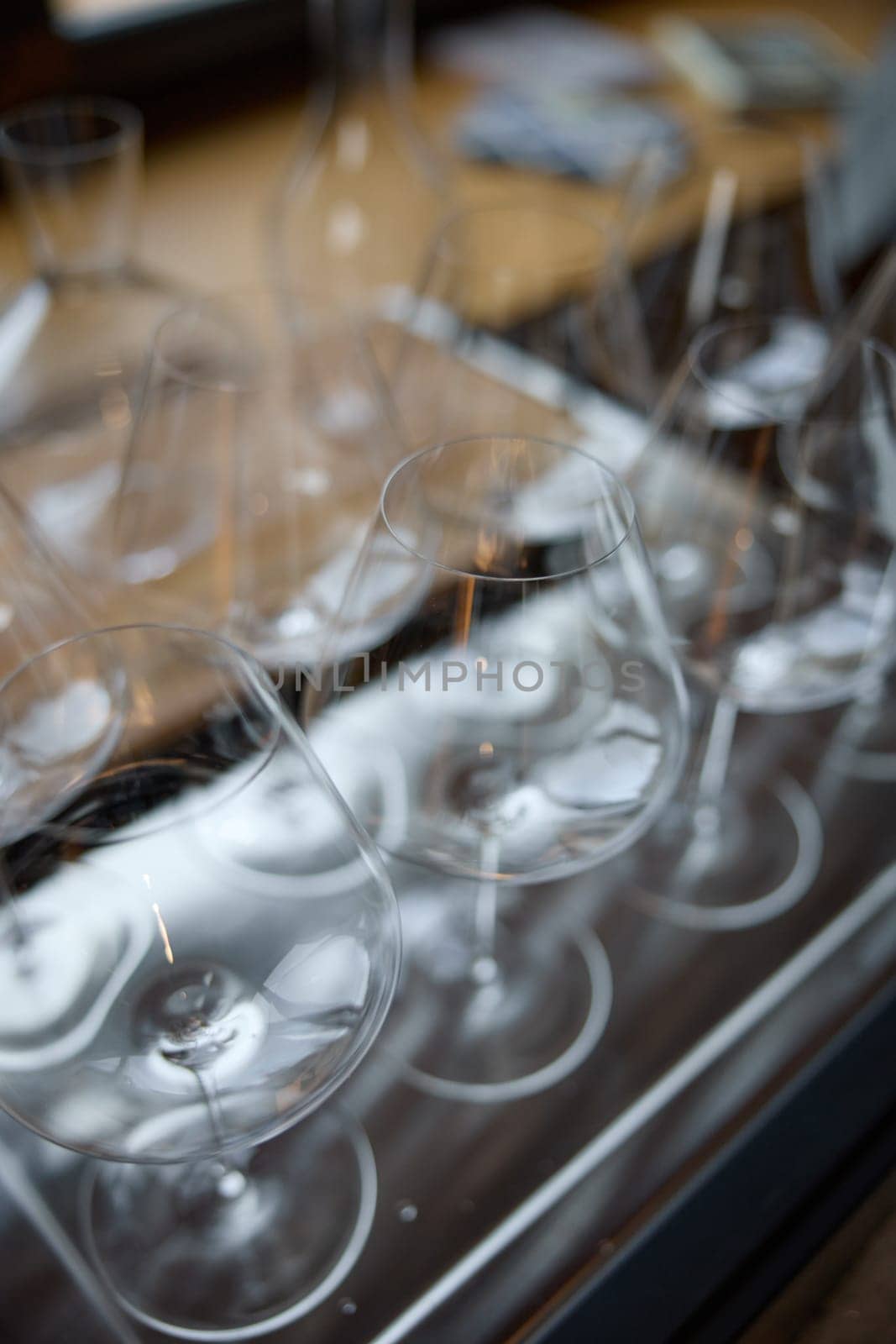 Clean wine glasses are on the table of a special wine cabinet, stylish table setting, ice, bottle of sparkling wine, light from window, decanter and degasser. High quality photo