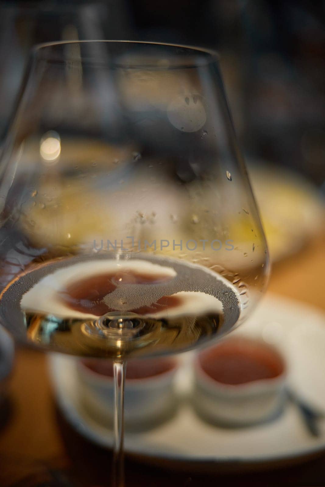 A glass of sparkling wine in close-up, Champagne tasting, Wine glasses are on the table, stylish table setting, sparkling wine bubbles, oysters and sea urchins, special sauce. High quality photo