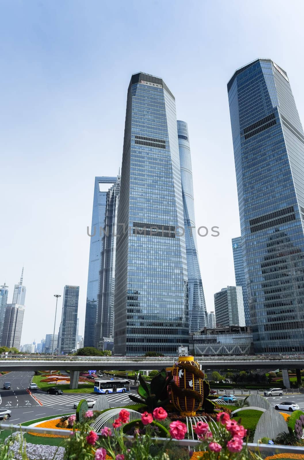 Shanghai, China - 1 April 2025: Modern skyscrapers including Shanghai Tower and Shanghai World Financial Center in Pudong financial district with urban traffic.