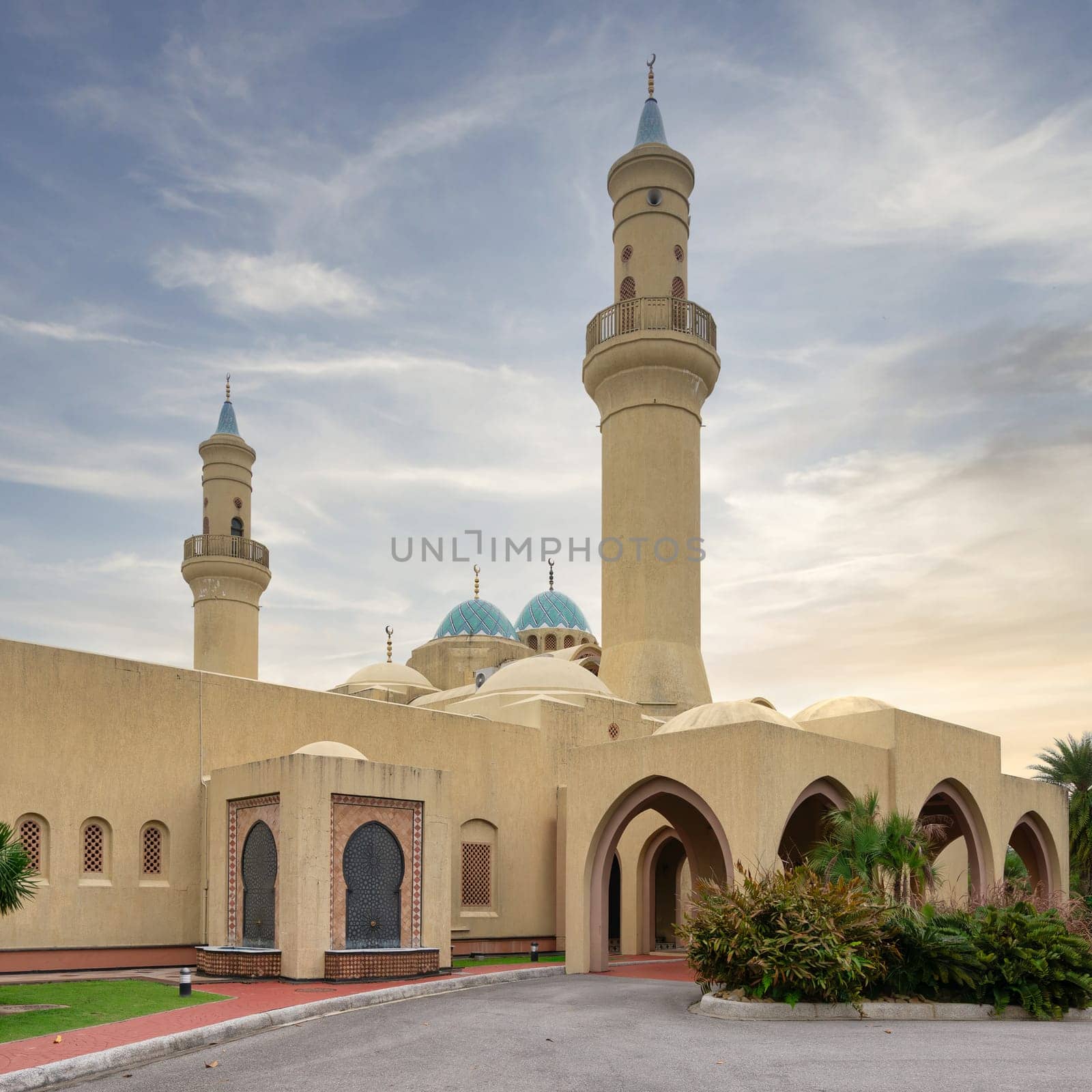 Ash Shaliheen Mosque, with its remarkable architecture and picturesque surroundings in Bandar Seri Begawan, Brunei Darussalam, stands out against the backdrop of a clear sunset sky