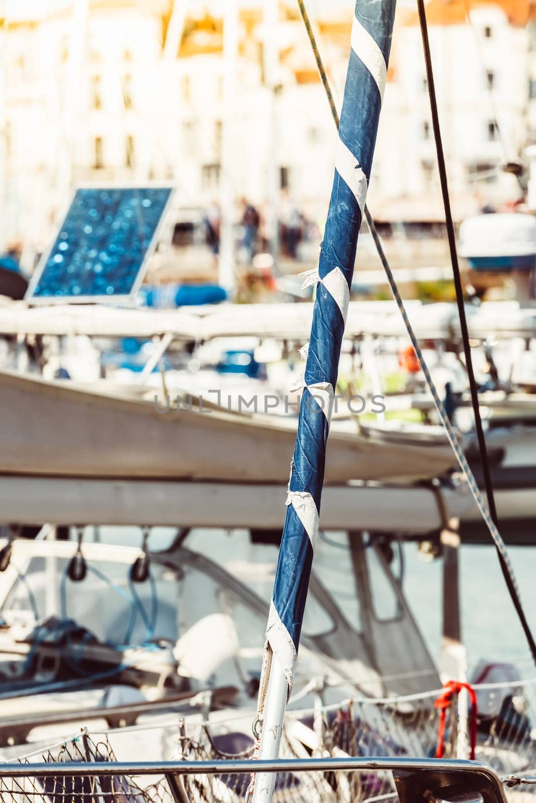 Yacht marina with sailboat masts and solar panel background, 