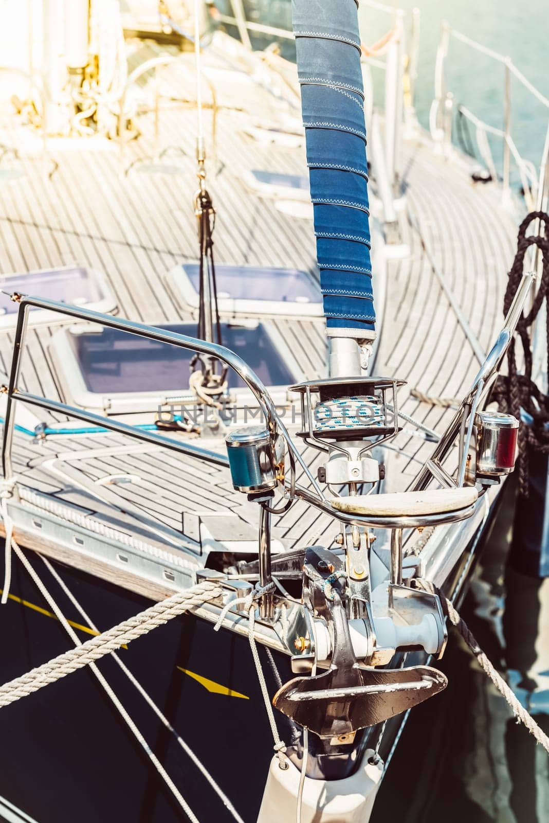 Sailboat deck with focus on rigging and sunlight reflection, background, 