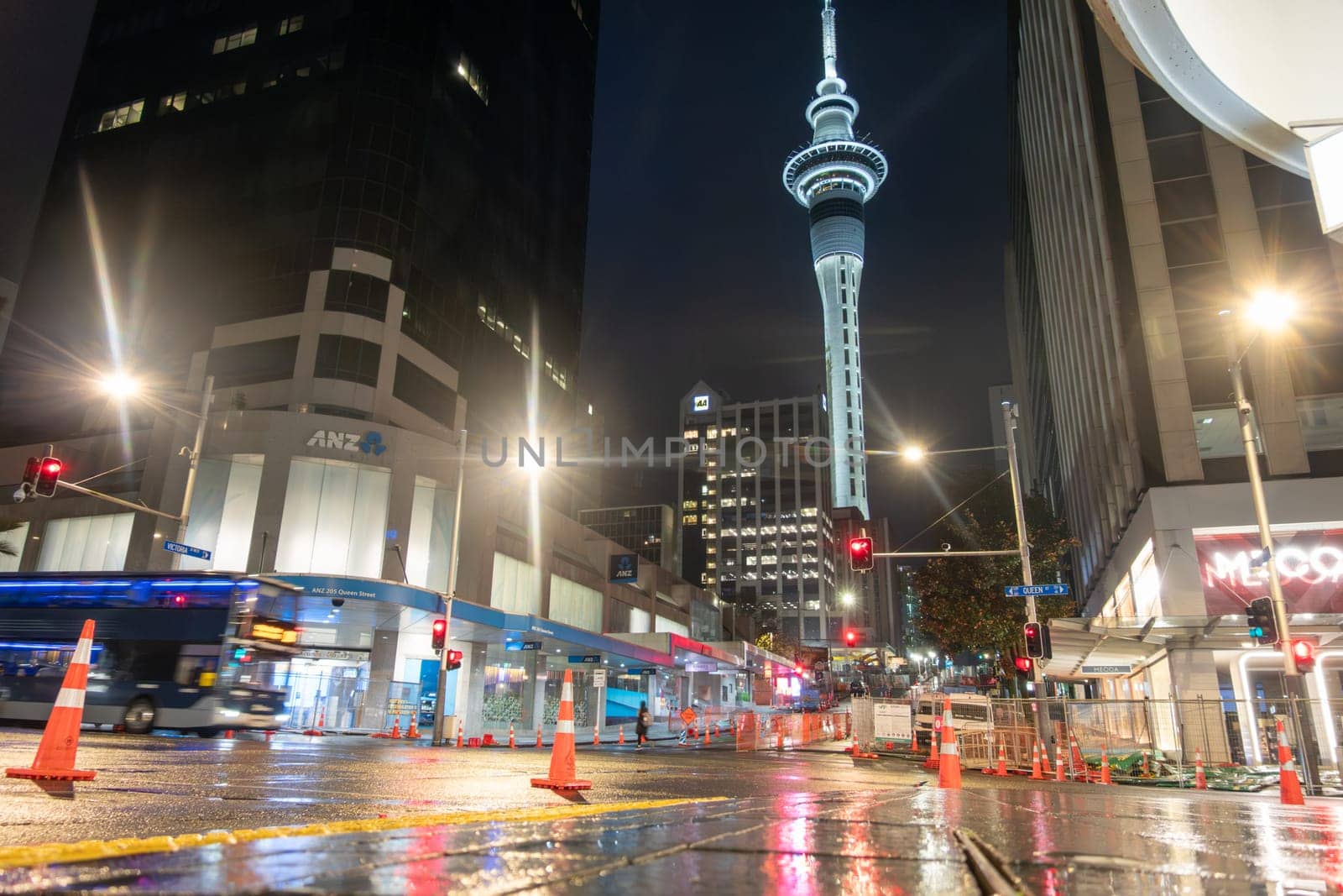 Auckland New Zealand - July 1 2023; Rainy night and wet city street in darkness of morning before city come to life on intersection where City Rail Link road construction is happening.