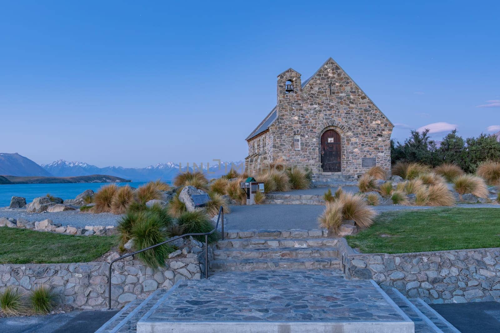 Historic Church of Good Sheppard famous tourist destination on shore of Lake Tekapo at twilight in New Zealand.