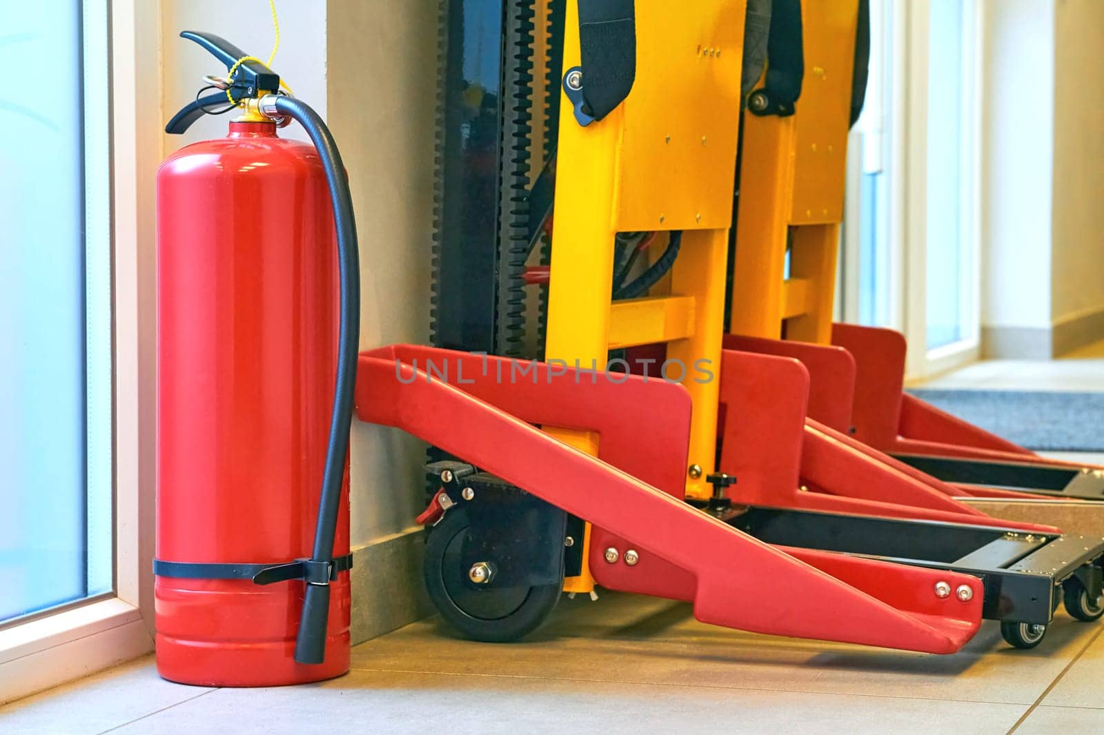 a portable device that discharges a jet of water, foam, gas, or other material to extinguish a fire