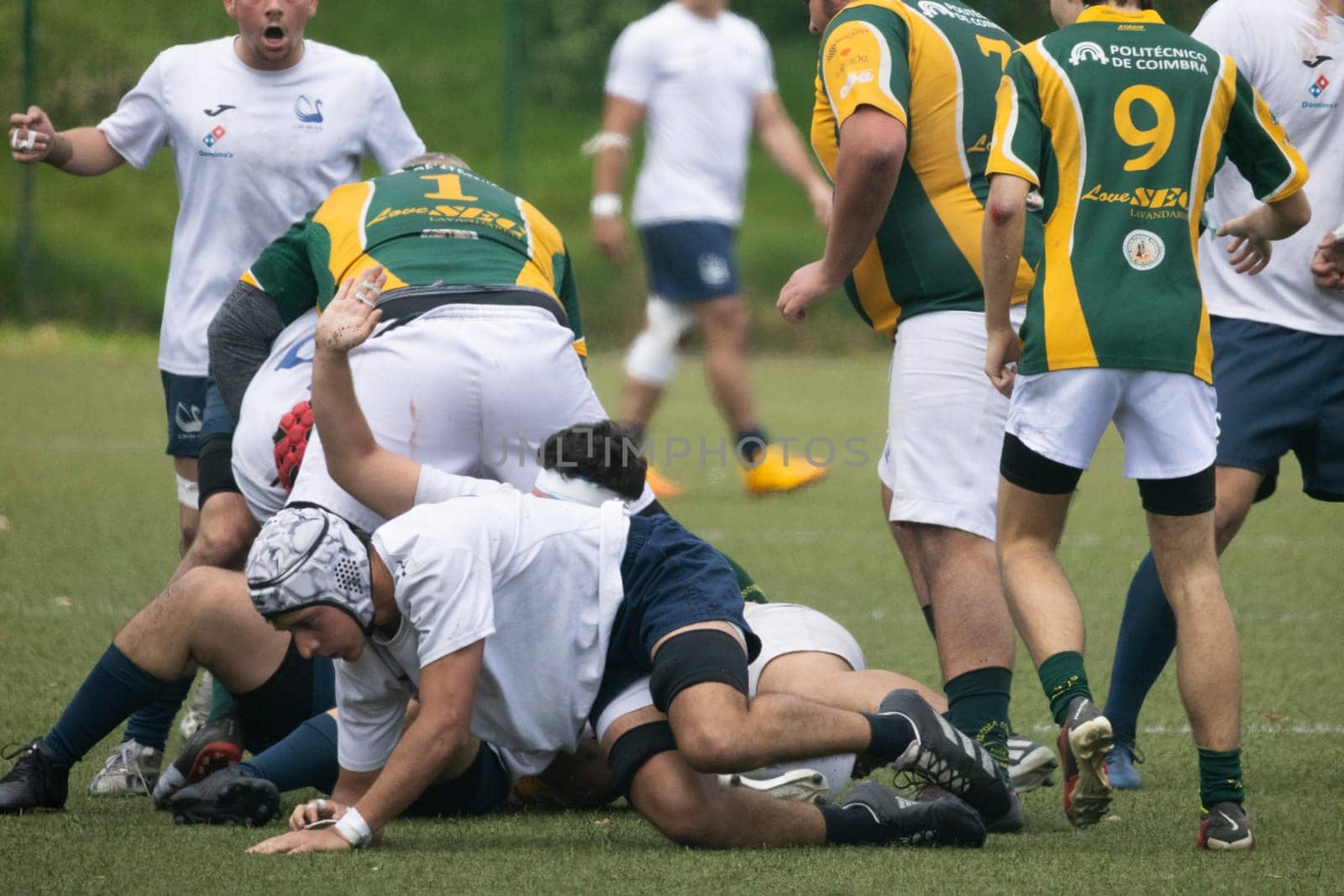 3 may 2025, lisbon. Portugal - oeiras vs ag - rugby players forming a ruck during a match, competing for the ball on a green field