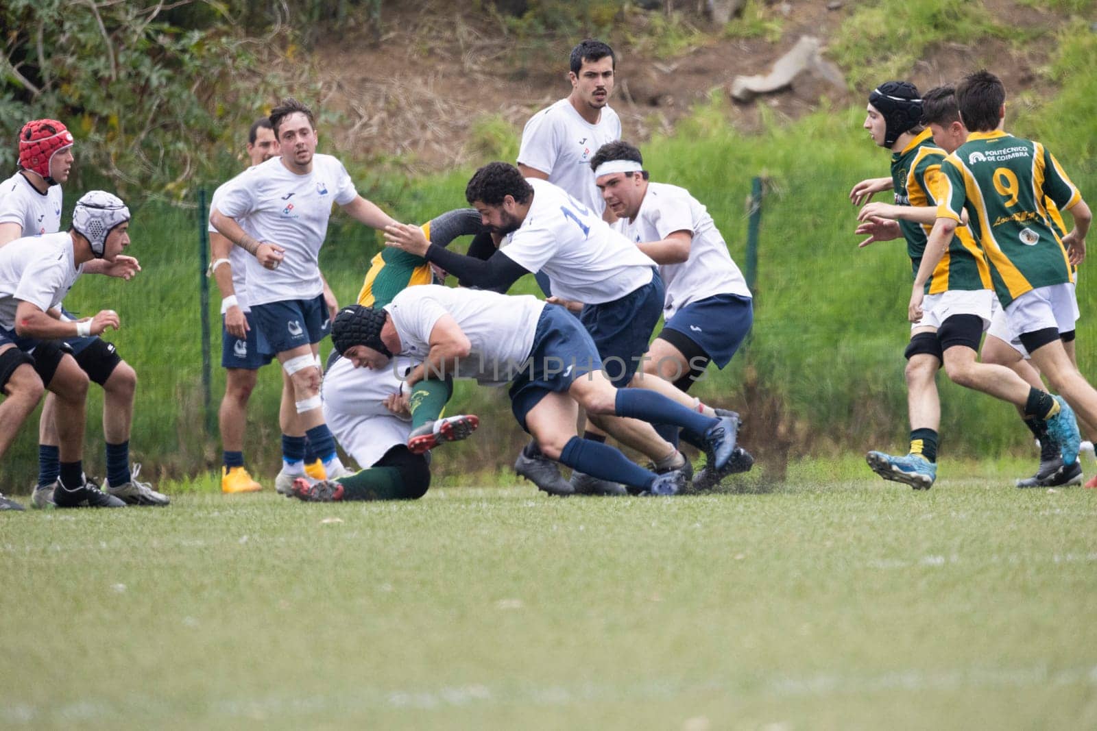 3 may 2025, lisbon. Portugal - oeiras vs ag - rugby players competing in a fierce match, tackling the opponent to the ground