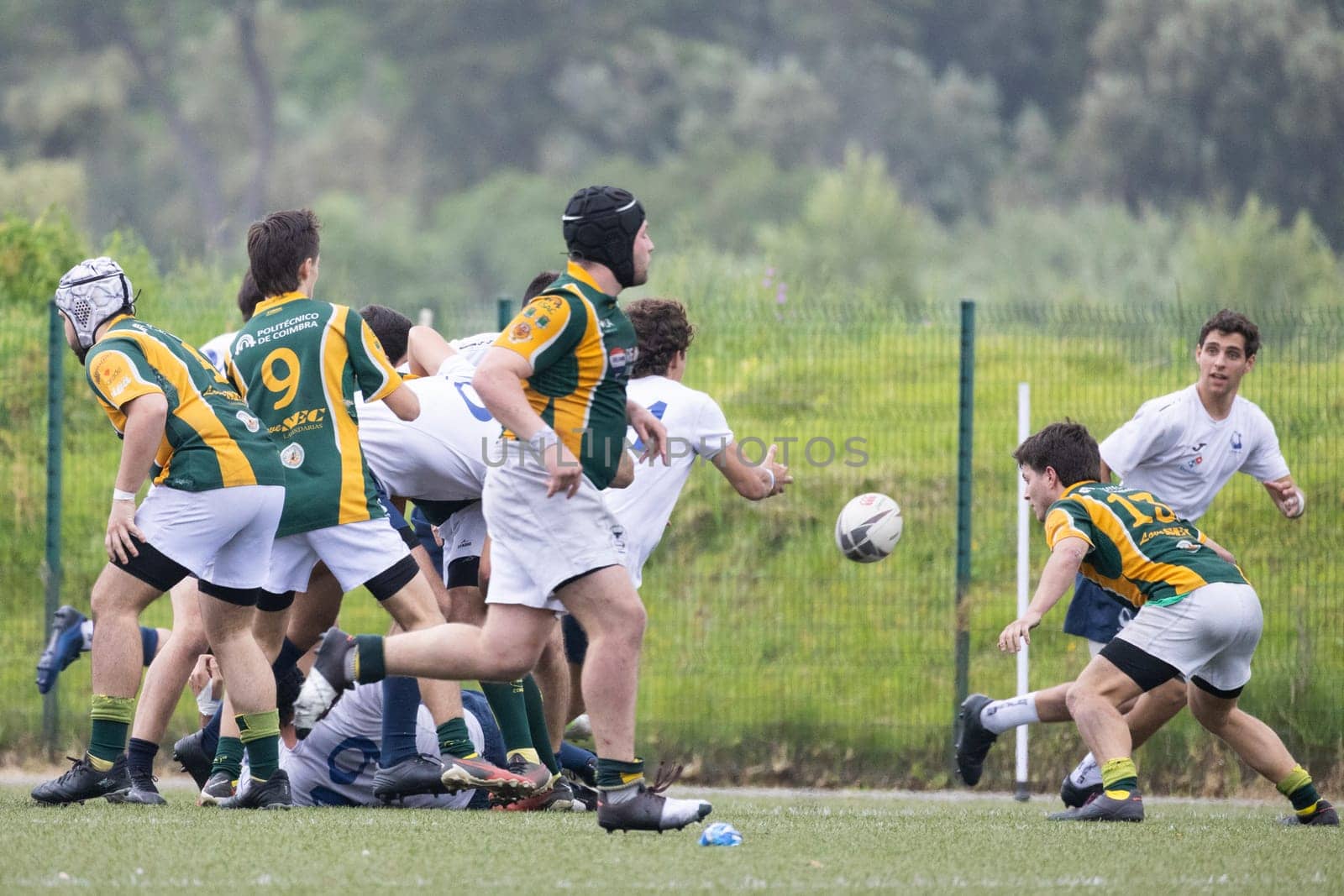3 may 2025, lisbon. Portugal - oeiras vs ag - rugby players passing the ball during a rugby game on a green field