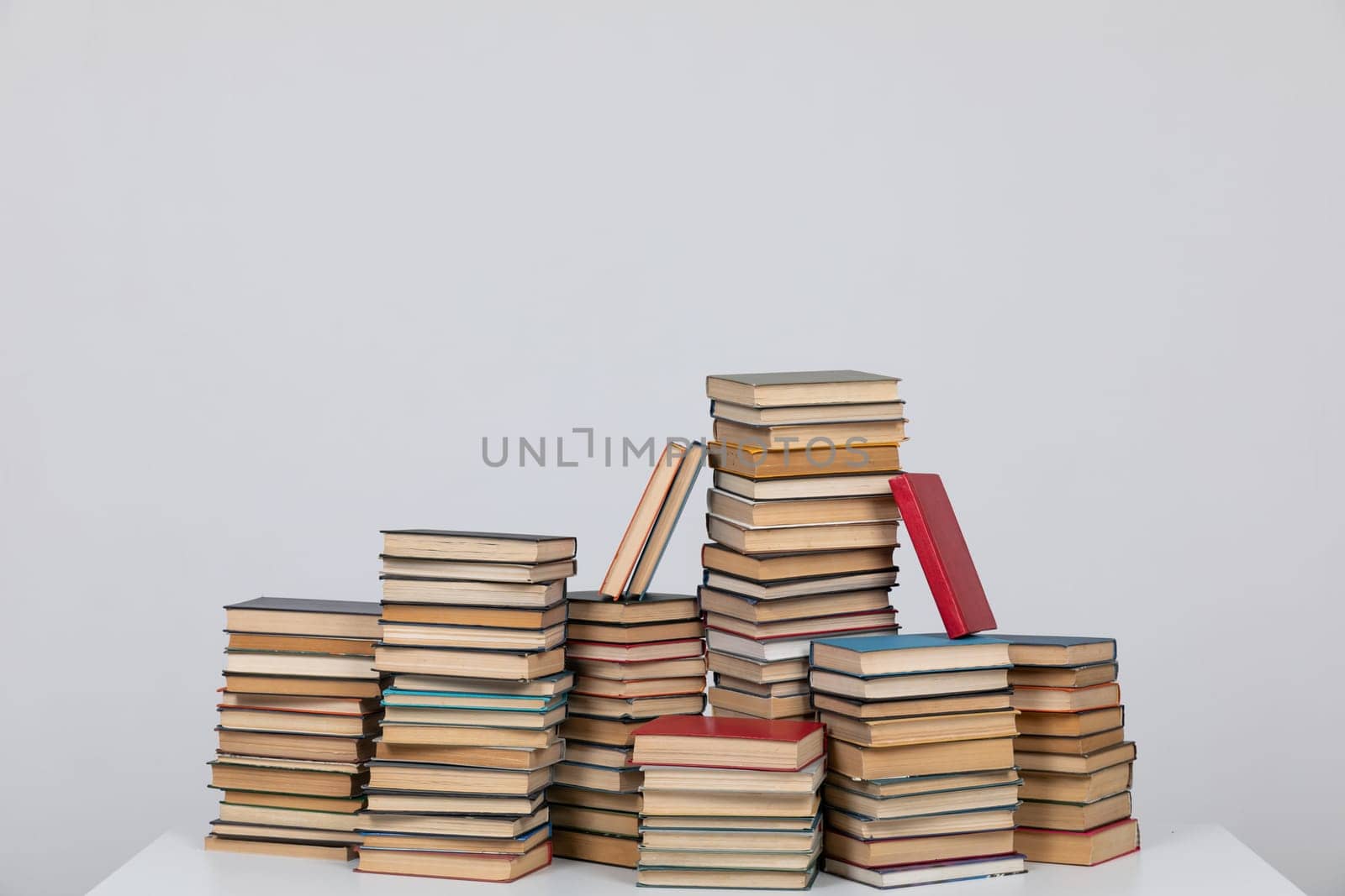 Stacks of educational books on a white background of the university library