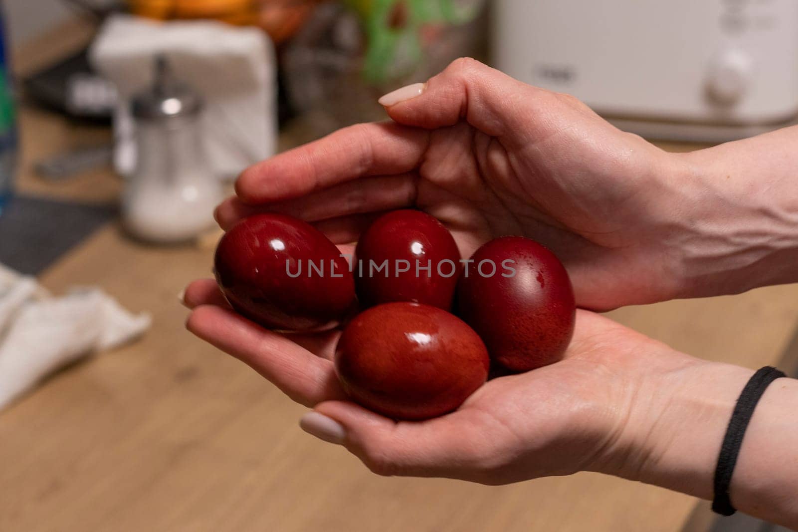 Woman holds Easter eggs just colored with onion peel