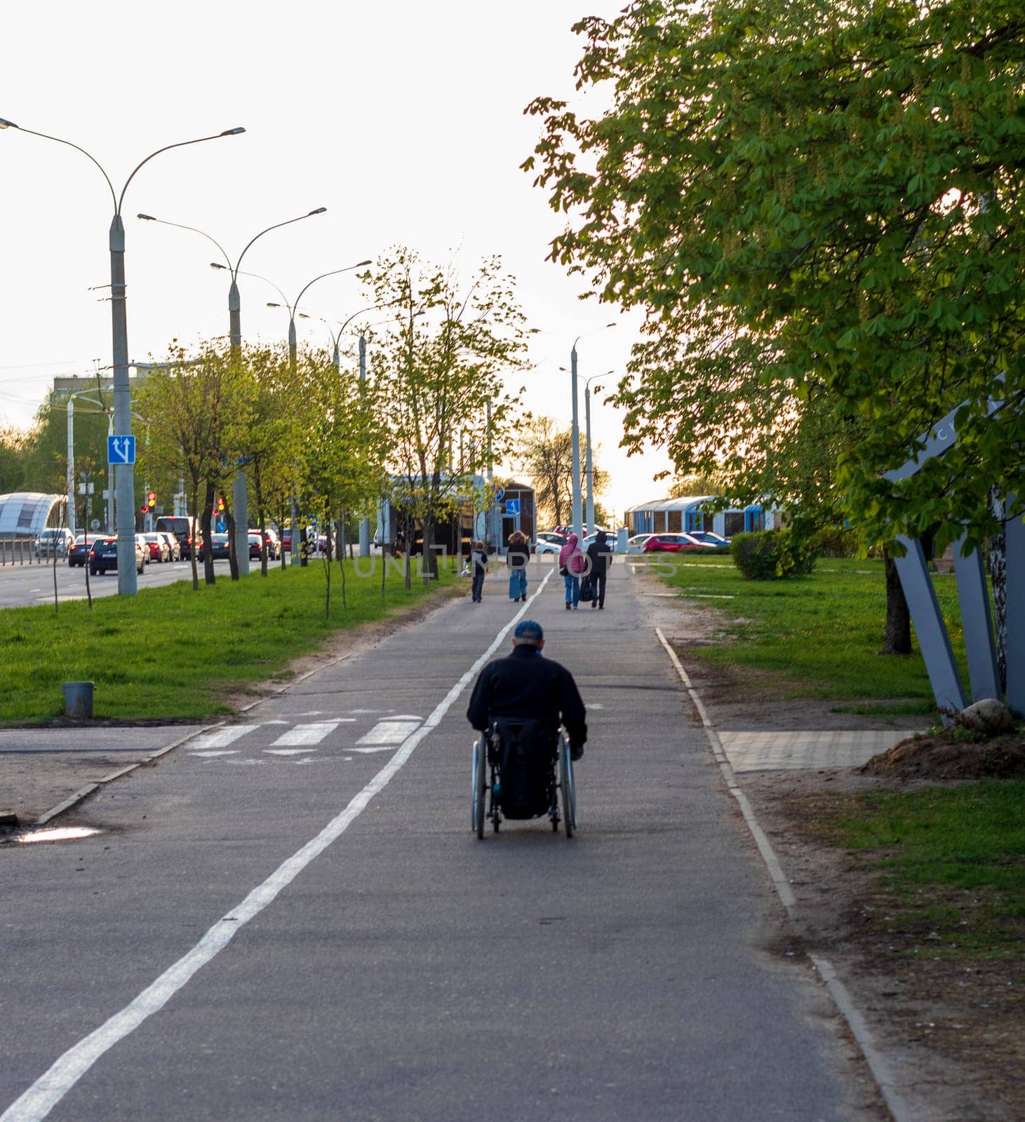 Shot of the handicapped man on the wheelchair on the city streets