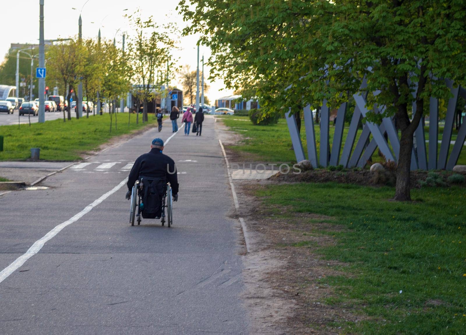Shot of the handicapped man on the wheelchair on the city streets