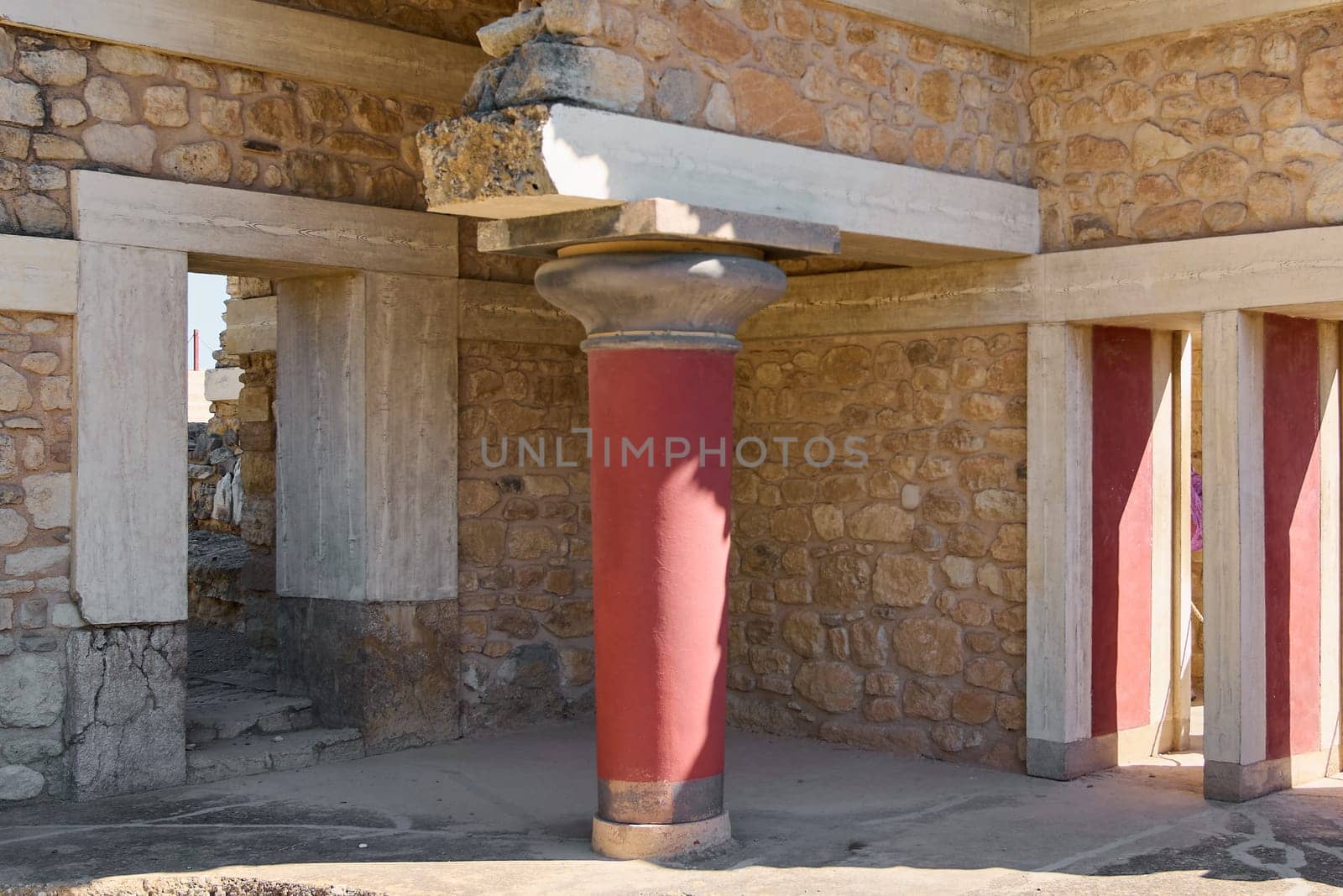 The iconic red columns and stone structures of Knossos Palace stand as a testament to Minoan civilization. The vibrant architecture highlights the grandeur of ancient Crete.