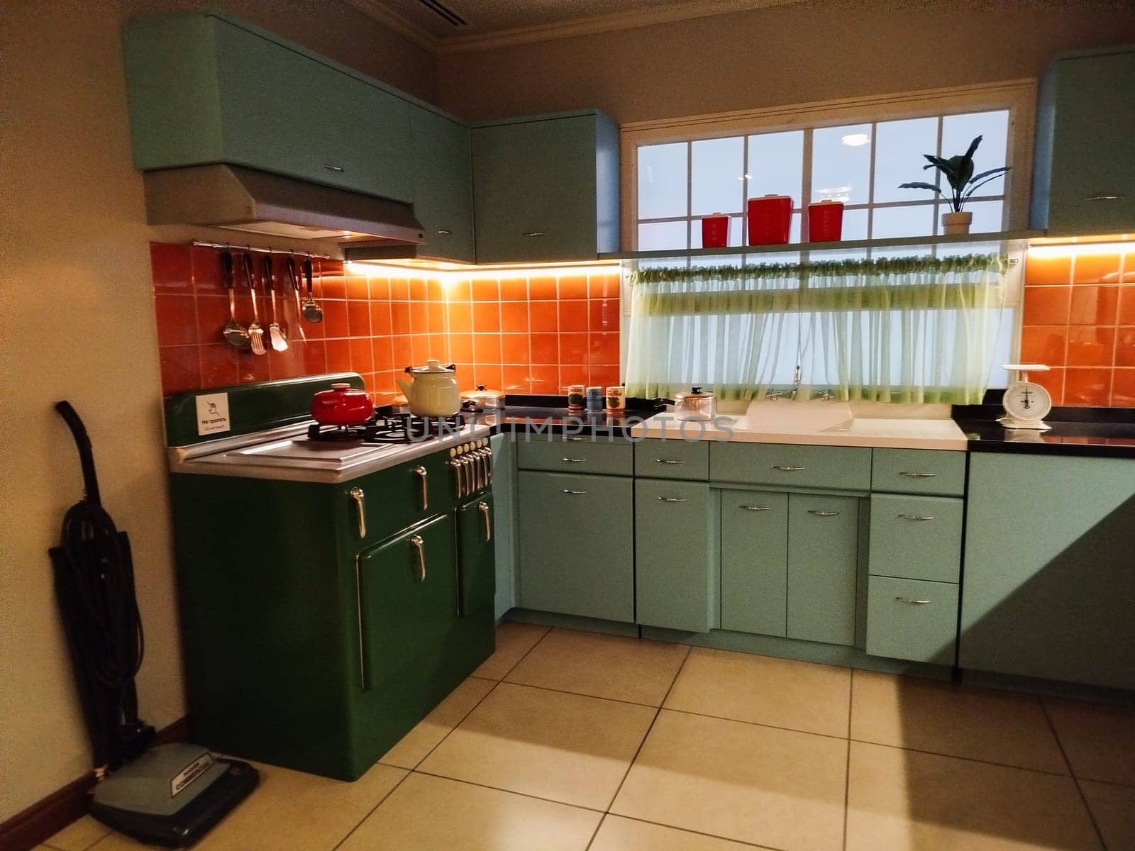 This well-lit kitchen features a blend of modern and retro design elements.