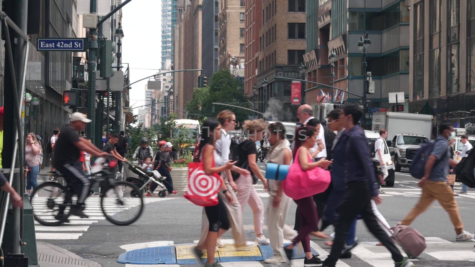 New York City, United States - 29 Aug 2023: Manhattan Midtown East 42 street, Lexington Lex avenue crossroad intersection. Urban road car traffic in USA. People, pedestrians on zebra.