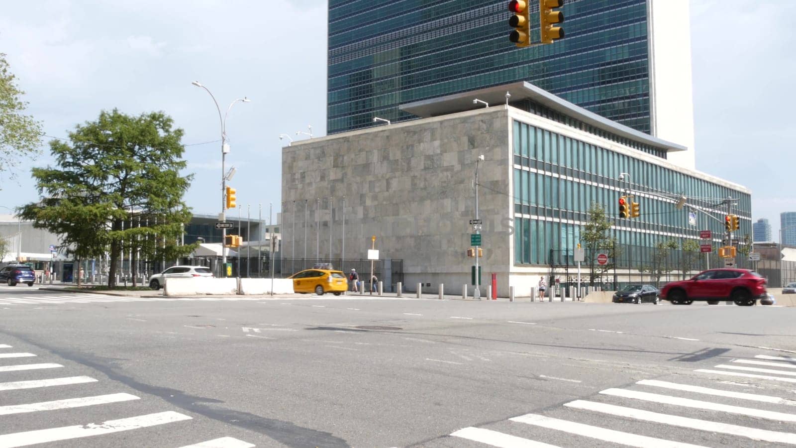 New York City, United States - 4 Sept 2023: United Nations UN Headquarters, Manhattan Midtown, USA. Diplomatic political international organization, General Assembly. Street traffic, yellow taxi car.