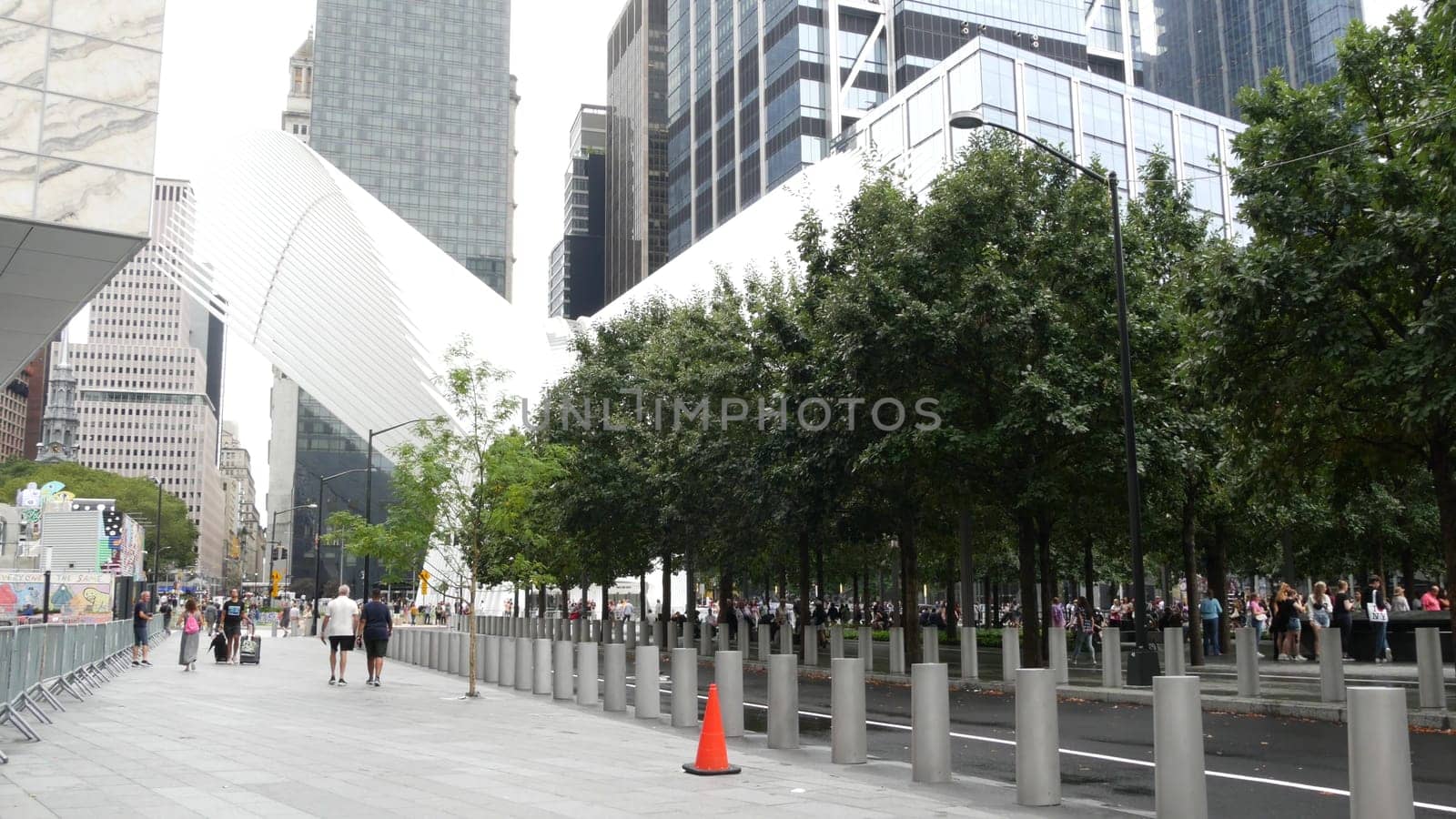 New York City, United States - 10 Sept 2023: Manhattan Downtown Financial District. People near World Trade Center Oculus. Memorial pools and 911 Museum area, Fulton street architecture in USA. Trees.