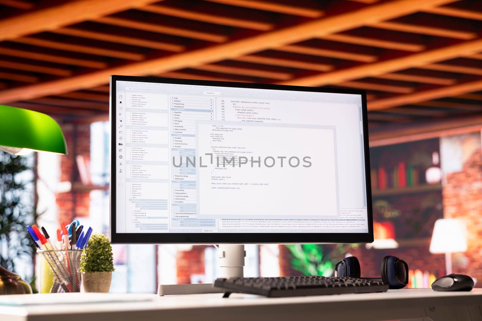 Lines of code written on PC workstation display on development tool application, close up. Debugging software programming language displayed on computer monitor in living room office